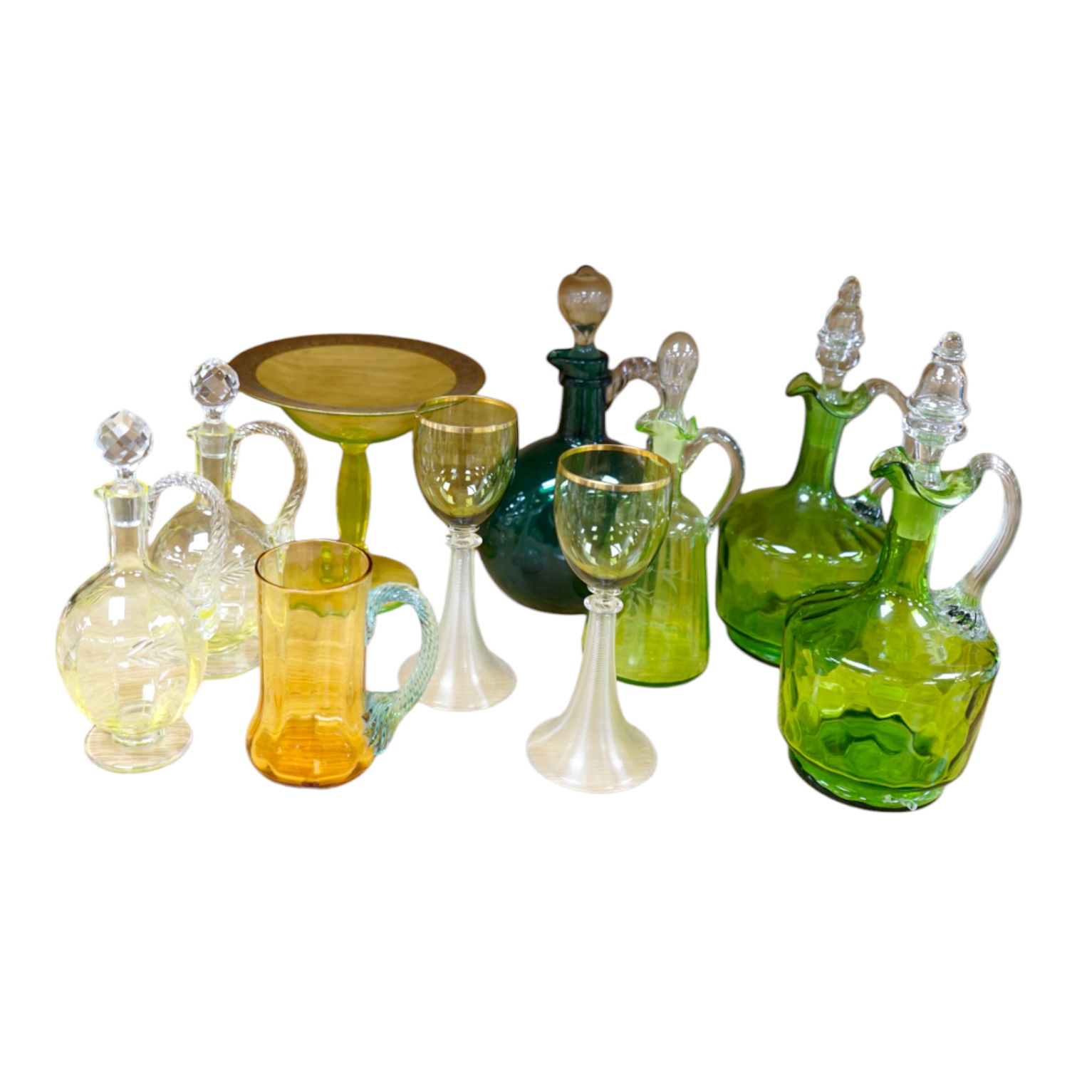 Ten glass items; a pair of green hock glasses, six liqueur decanters, a pedestal table centre and a mug. Condition - good.